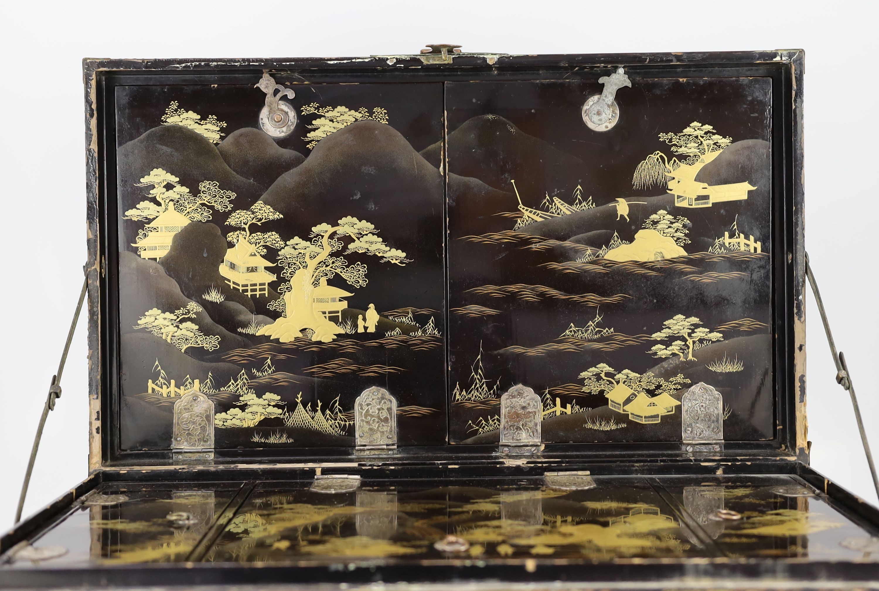 A Japanese lacquer fitted travelling trunk, 19th century, 55cm wide, H 23cm. D 32cm. Some losses to lacquer and wear to mounts